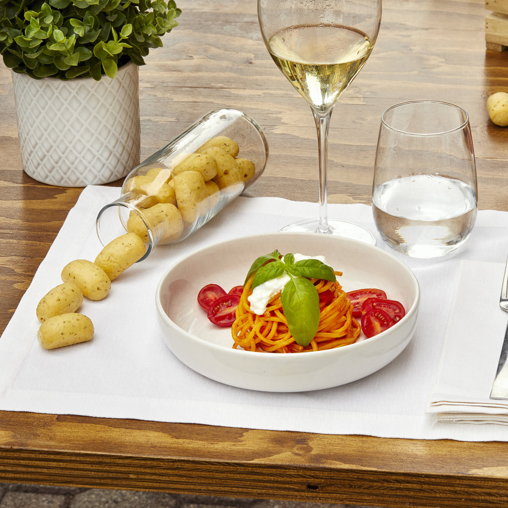 Italian aperitivo table with Imacoritti Grissini Bites, pasta dish, and white wine