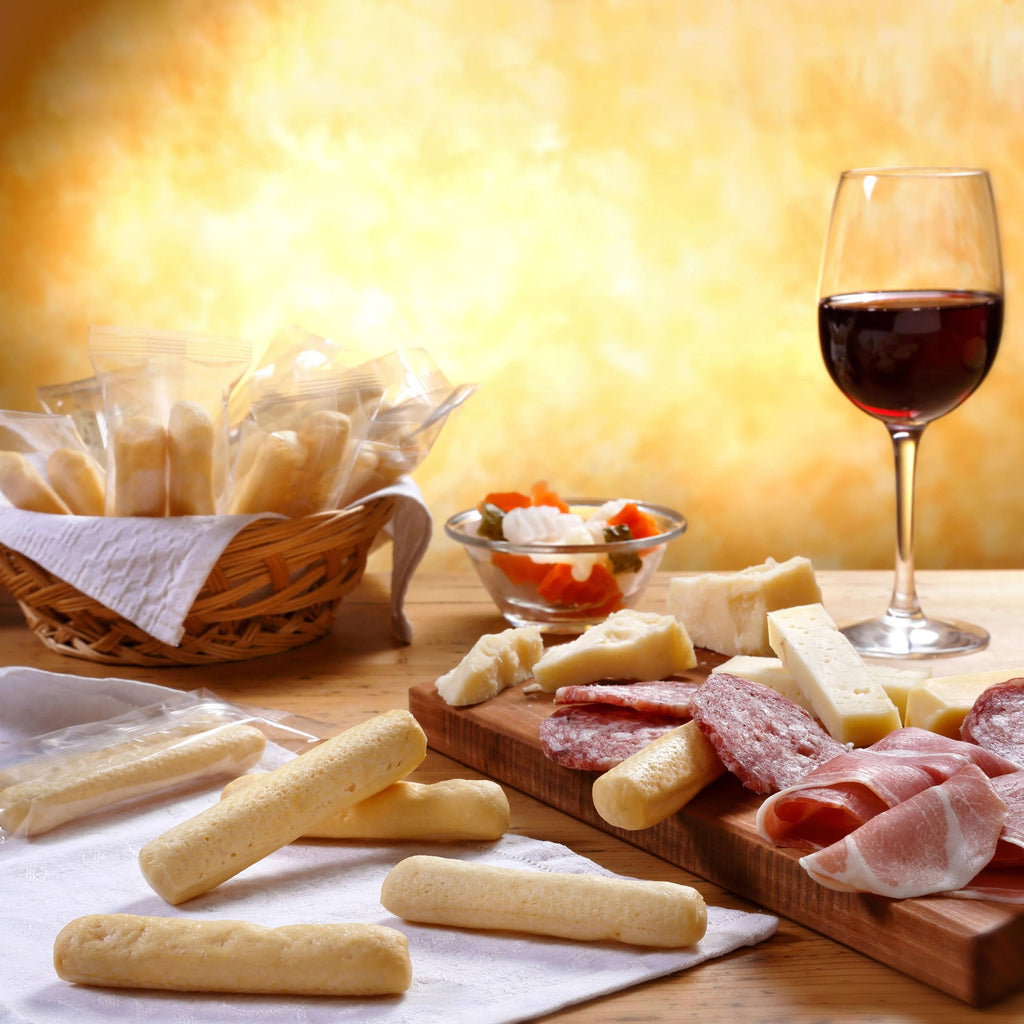 I Macoritti mini breadsticks served with charcuterie, cheese board, and red wine for appetizer pairing