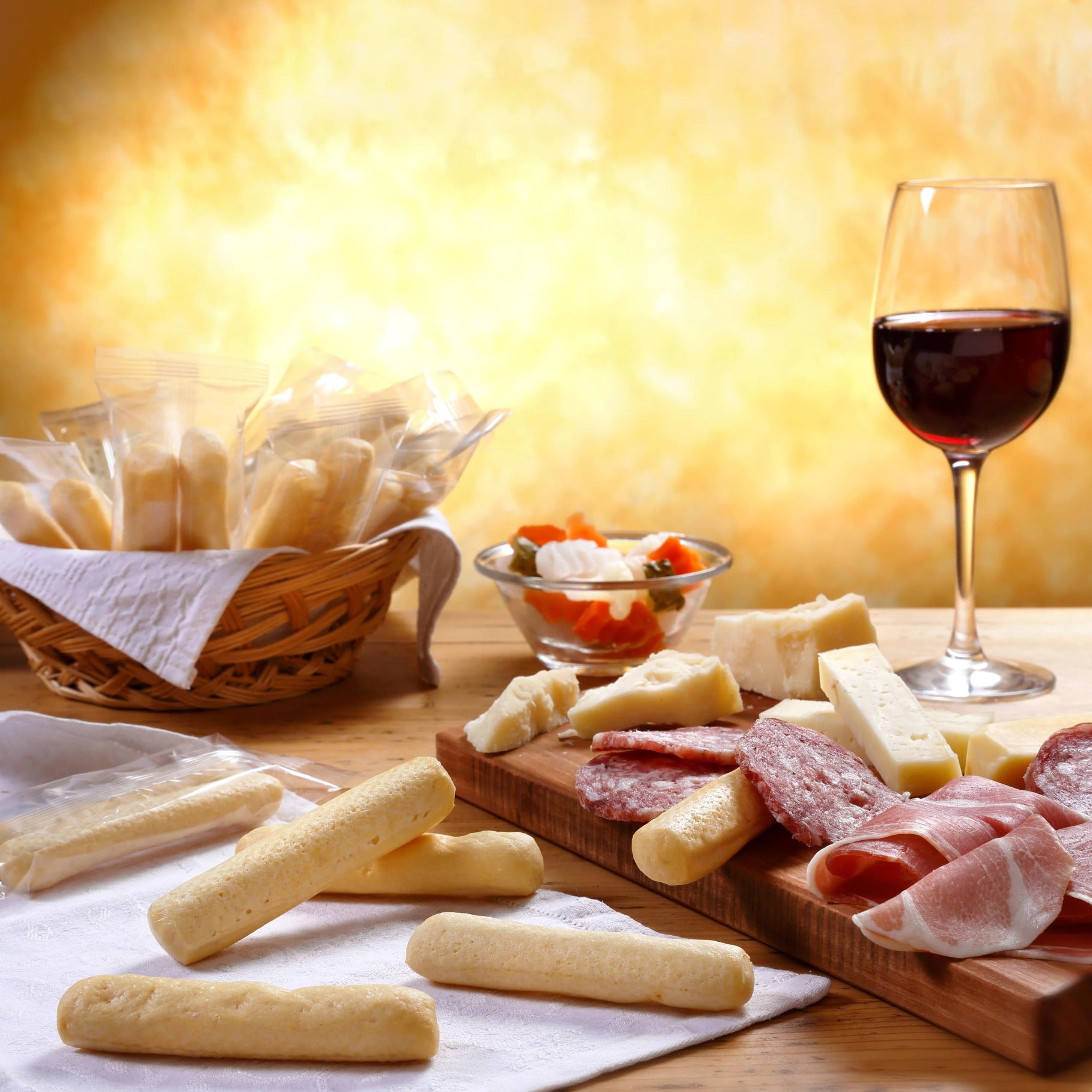 I Macoritti mini breadsticks served with charcuterie, cheese board, and red wine for appetizer pairing